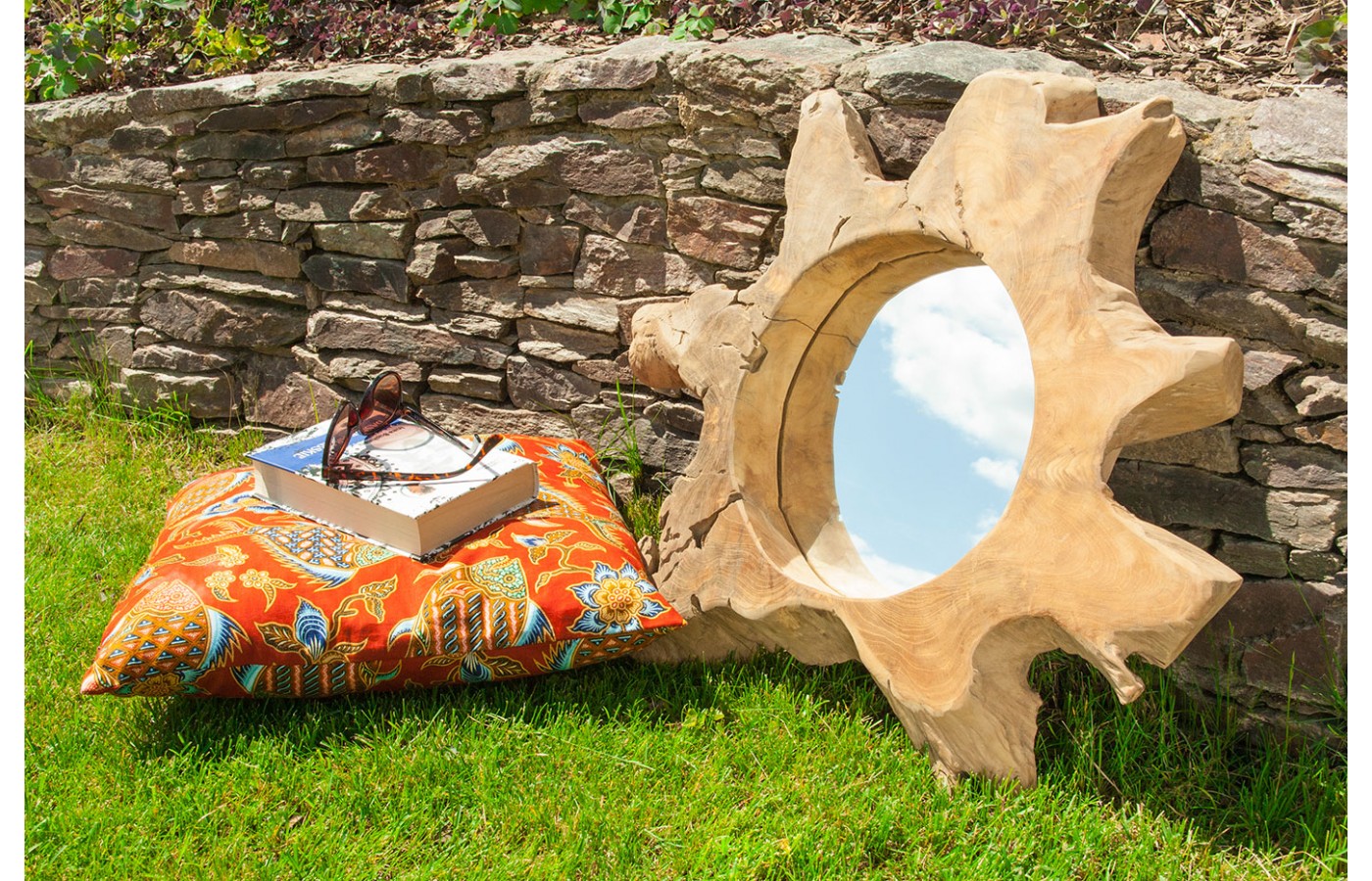 A mirror in a teak wood frame