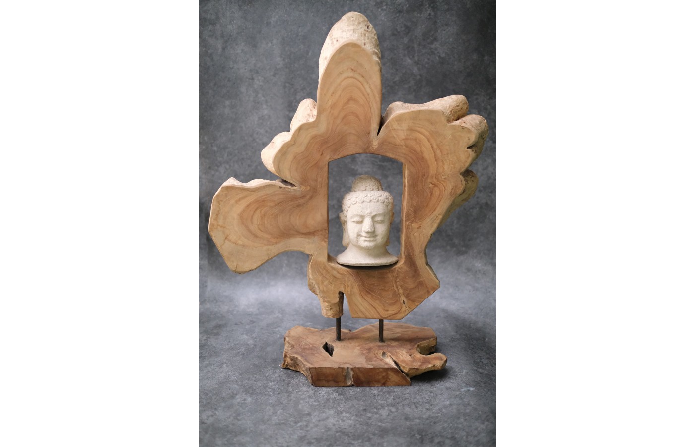 Buddha head surrounded by teak wood