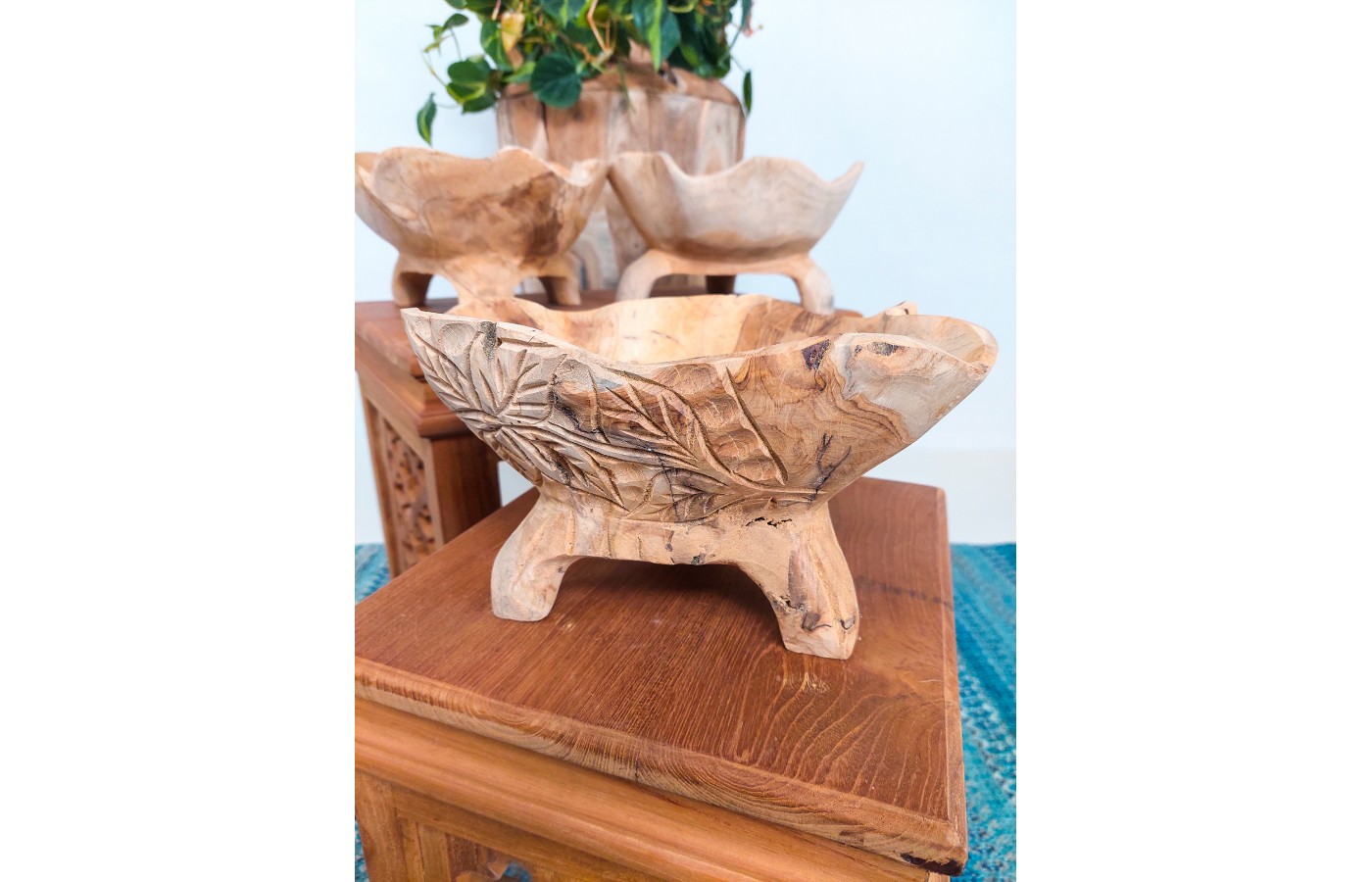 Wooden bowl on three legs with carvings